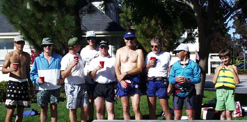 At the beach with the required beverage.  Al Mirel, Spike Leonard (Race Committee),  Mark Zimmer, Rolf Jaeger, Ron Simon, Glenn Taylor, Dick Brundle, Lynn, Martin Taylor.